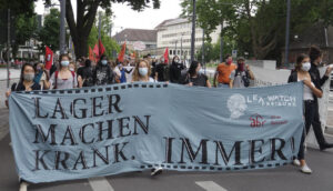 Fronttransparent auf Demo in Freiburg: Lager machen krank. IMMER